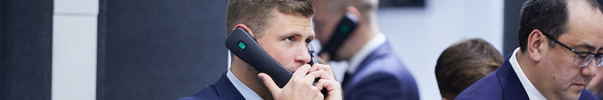SF LME Floor Person Holding Two Phones B1171
