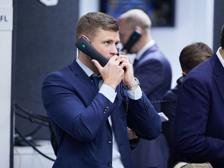 SF LME Floor Person Holding Two Phones B1171