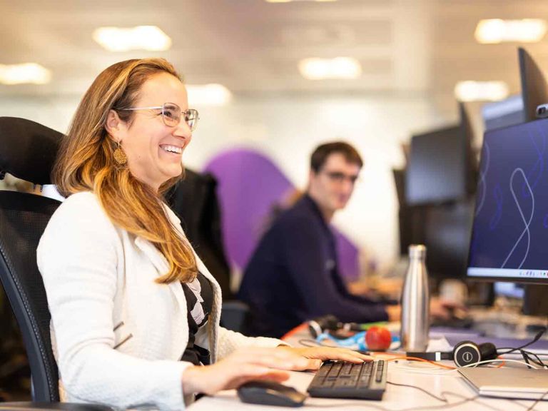 SF Person Smiling At Their Desk 487